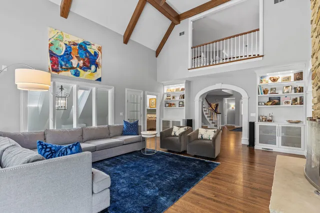 a living room with furniture a flat screen tv and a large window