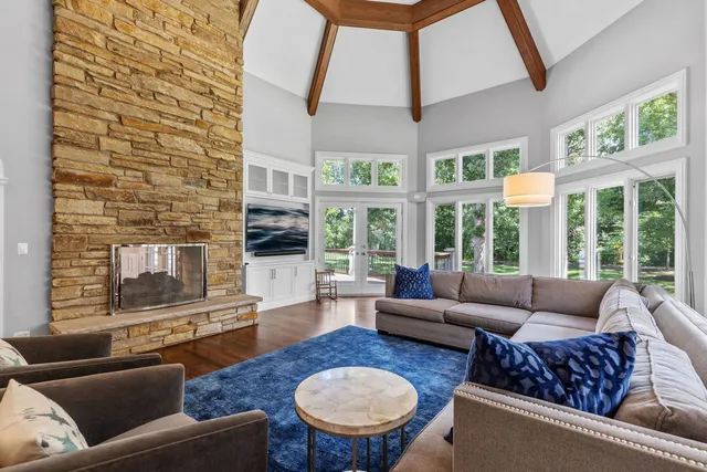 a dining area with a table chairs and a kitchen view
