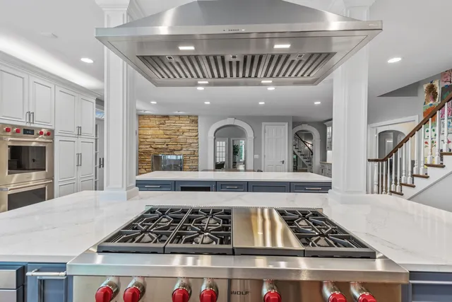 a large kitchen with a table and chairs in it