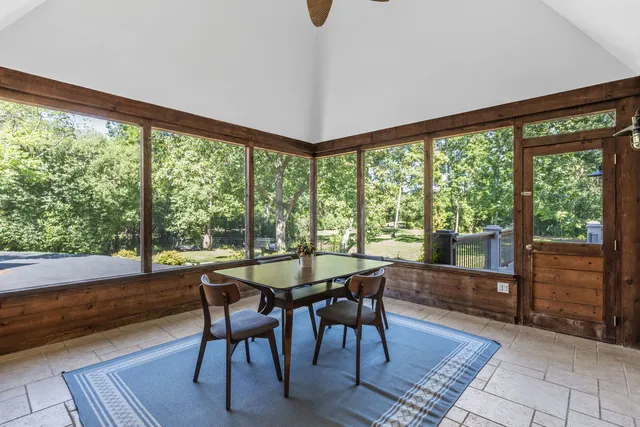a view of a room with a table and chairs