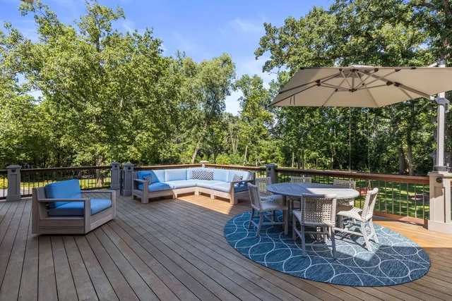 a living room with furniture a rug and a book shelf