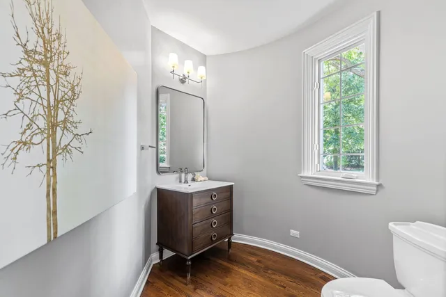 a spacious bedroom with a large bed and a wooden floor