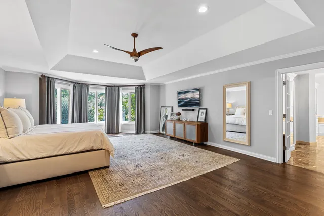 a spacious bedroom with a bed and a dresser