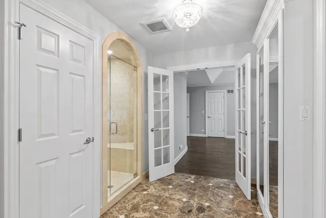 a bathroom with a granite countertop toilet a sink and a mirror