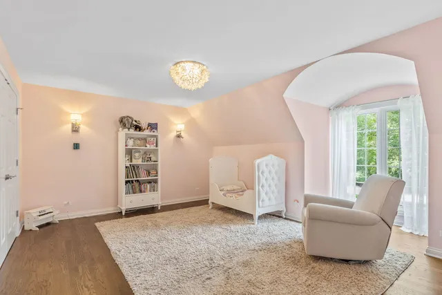 a living room with furniture a pool table and a large window