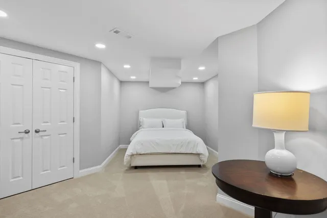 a view of a house with a big yard and large trees