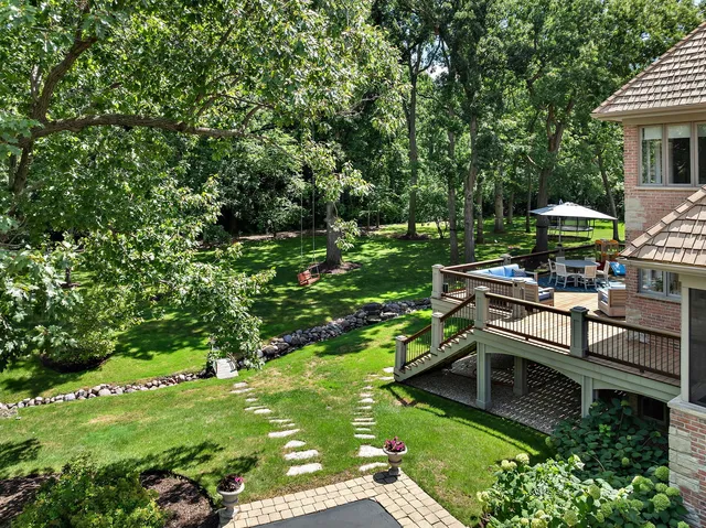 a view of a house with backyard and sitting area
