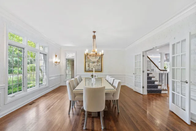 a view of a dining room with furniture wooden floor and chandelier