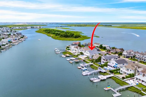 an aerial view of a house with wooden floor table and chairs