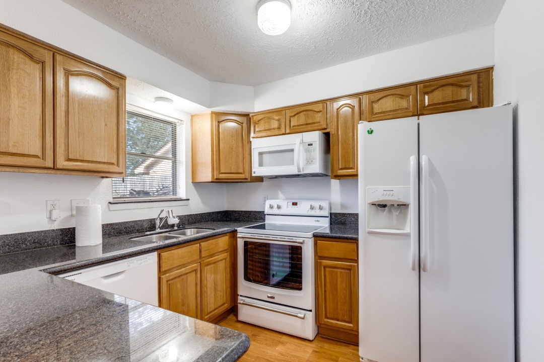 16210 Tibet Road Friendswood, TX 77546 - Photo 11 of 27 a kitchen with stainless steel appliances granite countertop a refrigerator sink and stove