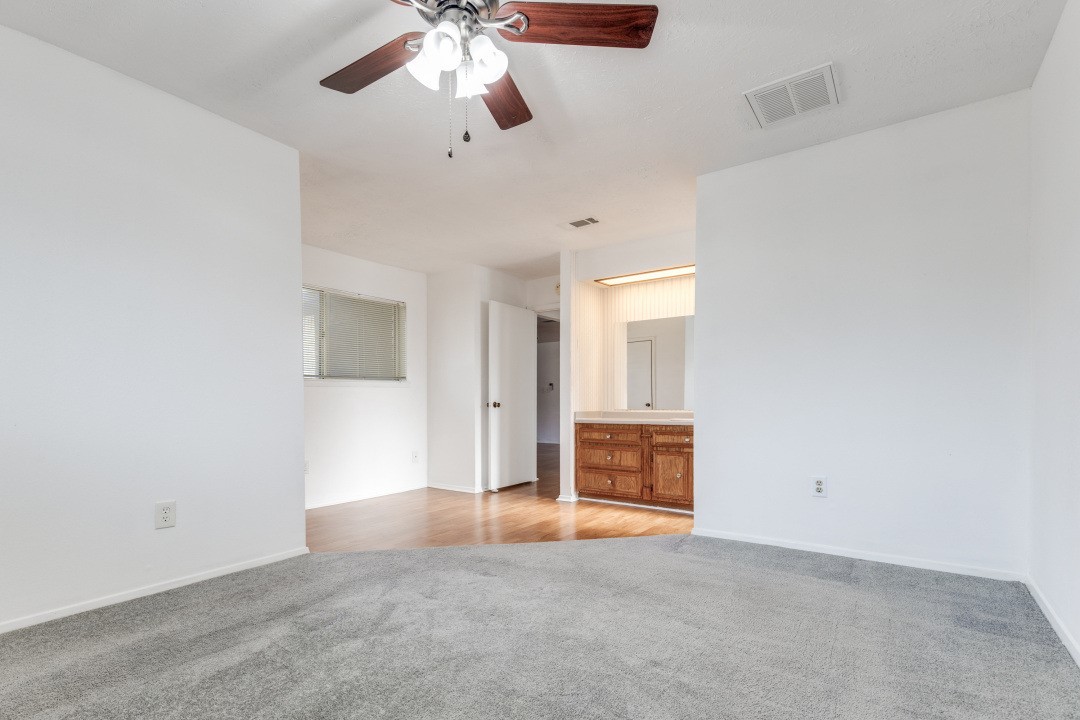 16210 Tibet Road Friendswood, TX 77546 - Photo 12 of 27 an empty room with chandelier fan and windows