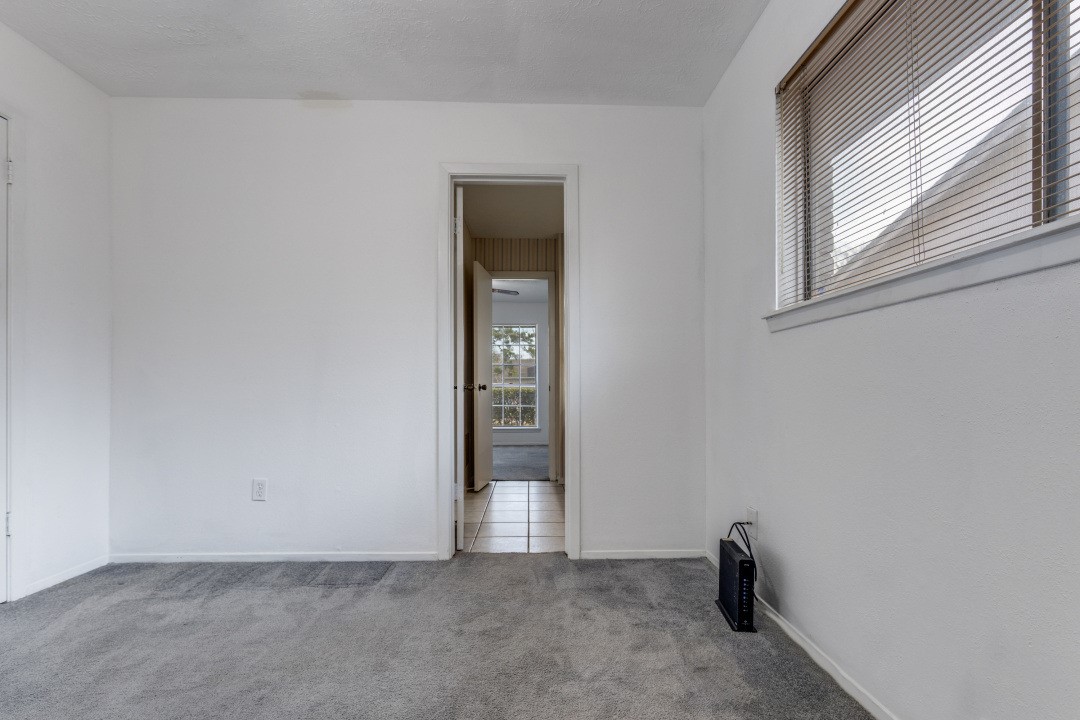 16210 Tibet Road Friendswood, TX 77546 - Photo 14 of 27 a view of an empty room with closet and a window