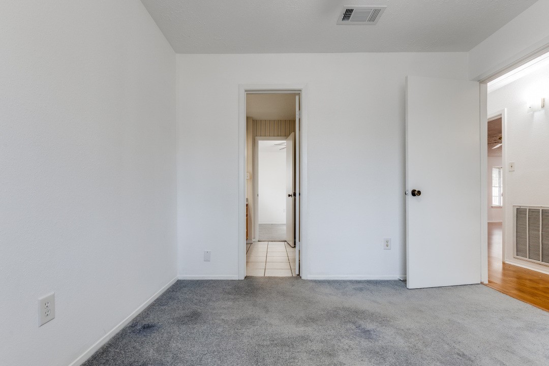 16210 Tibet Road Friendswood, TX 77546 - Photo 17 of 27 a view of an empty room with closet and a window