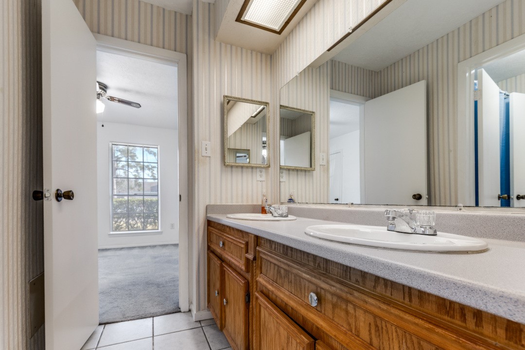 16210 Tibet Road Friendswood, TX 77546 - Photo 18 of 27 a bathroom with a sink and a mirror