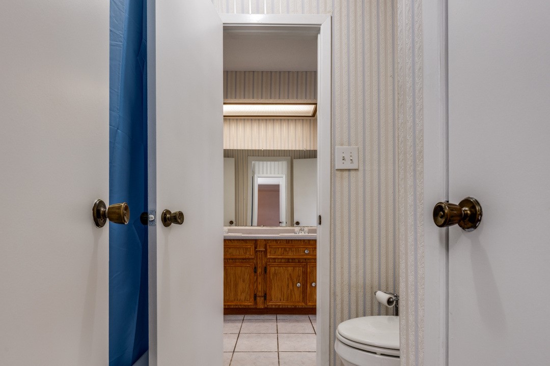 16210 Tibet Road Friendswood, TX 77546 - Photo 20 of 27 a bathroom with a toilet and a shower