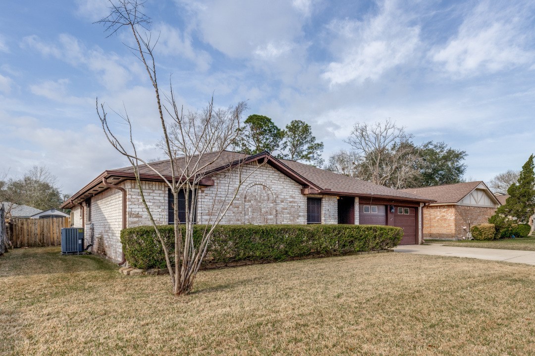 16210 Tibet Road Friendswood, TX 77546 - Photo 3 of 27 a front view of a house with a yard and potted plants
