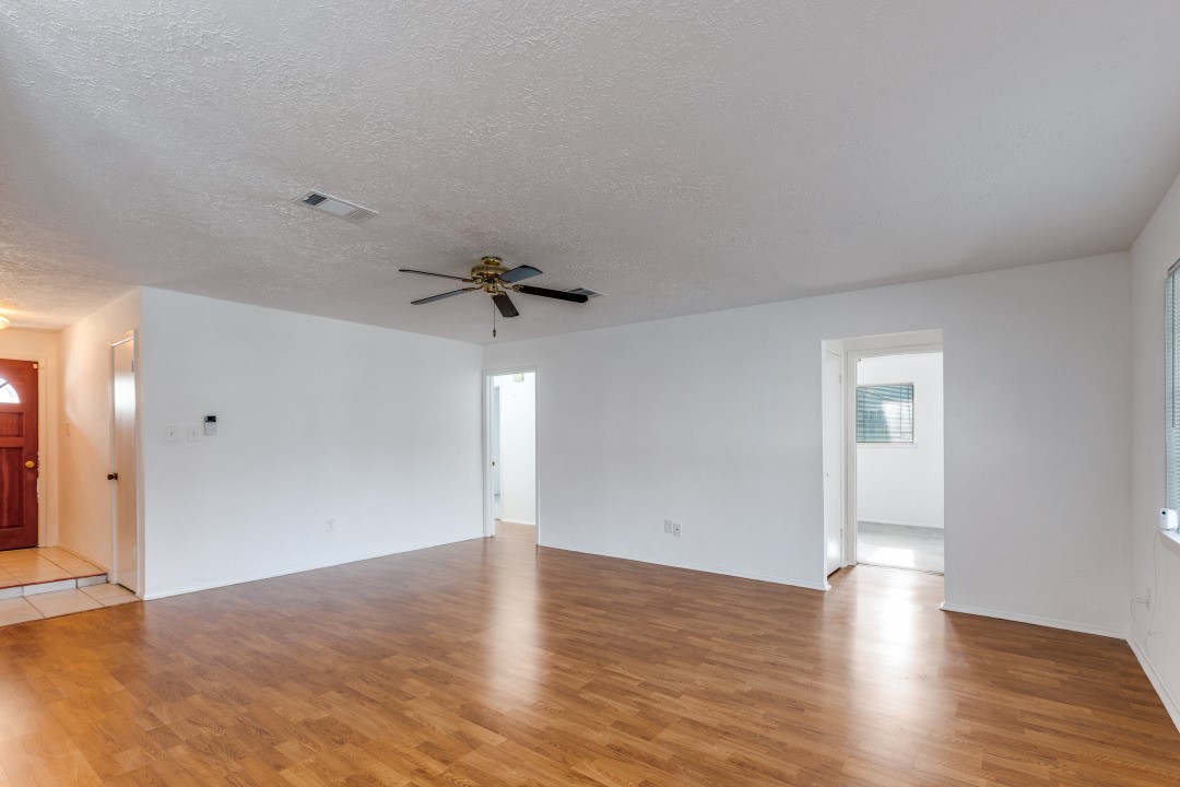 16210 Tibet Road Friendswood, TX 77546 - Photo 6 of 27 a view of empty room with wooden floor and fan