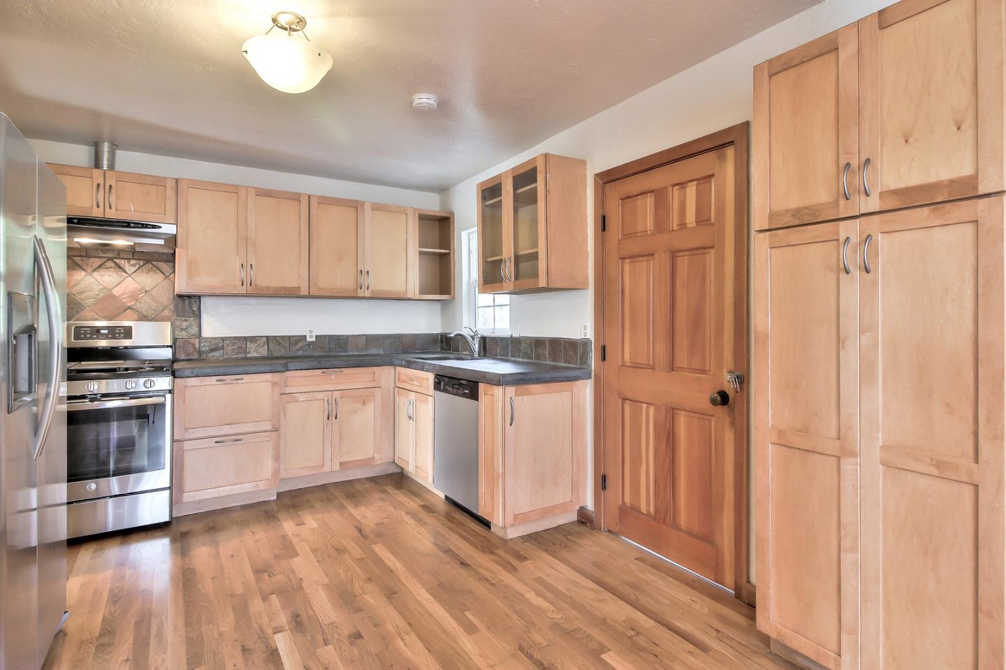 30 Heiner Road Watsonville, CA 95076 - Photo 13 of 50 a kitchen with granite countertop cabinets stainless steel appliances and a island