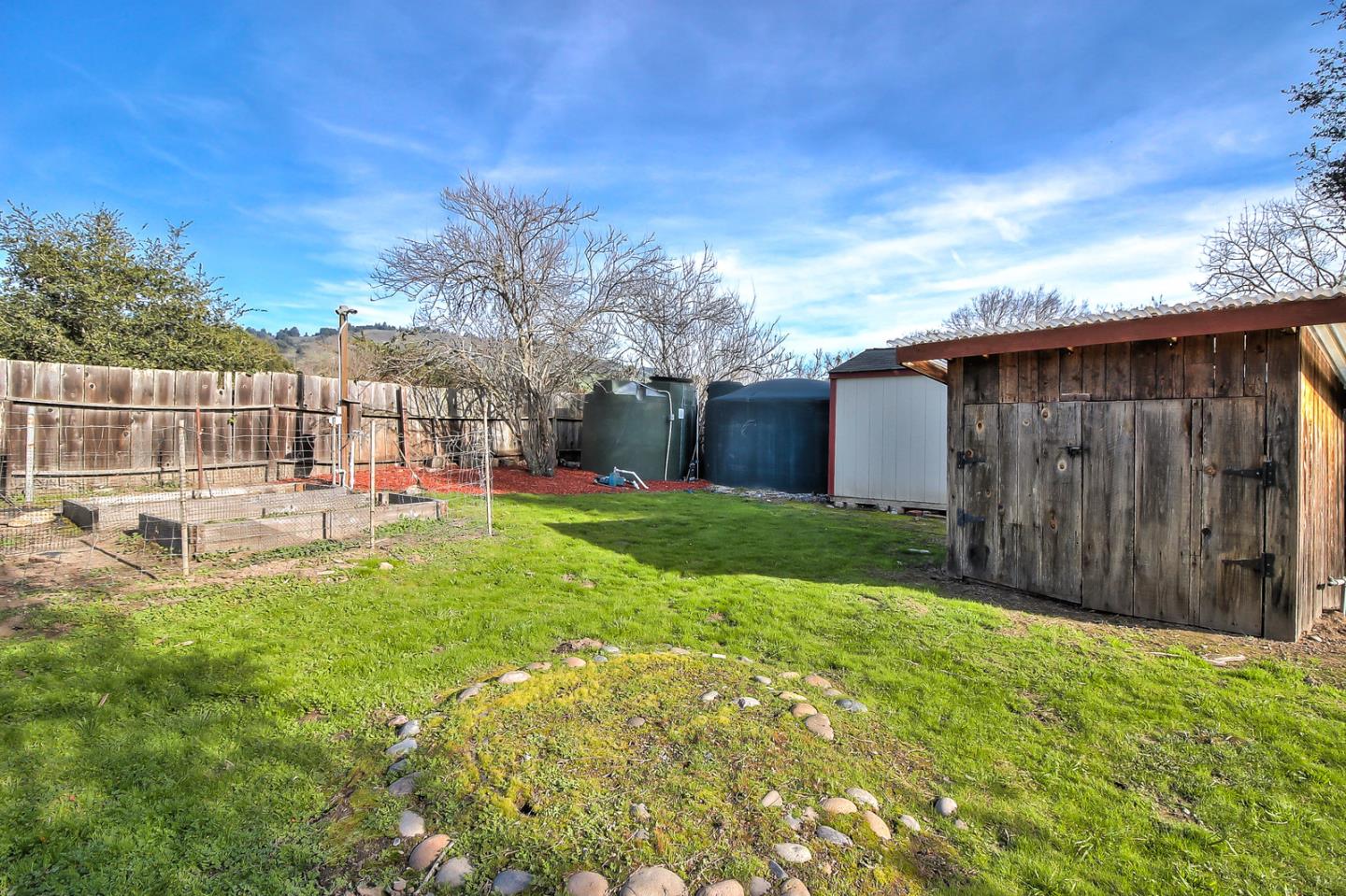 30 Heiner Road Watsonville, CA 95076 - Photo 43 of 50 a view of a backyard with table and chairs and wooden fence