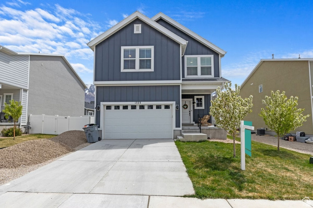 1323 South Raintree Lane Santaquin, UT 84655 - Photo 1 of 23 View of front facade with board and batten siding, a garage, concrete driveway, a front yard, and a porch