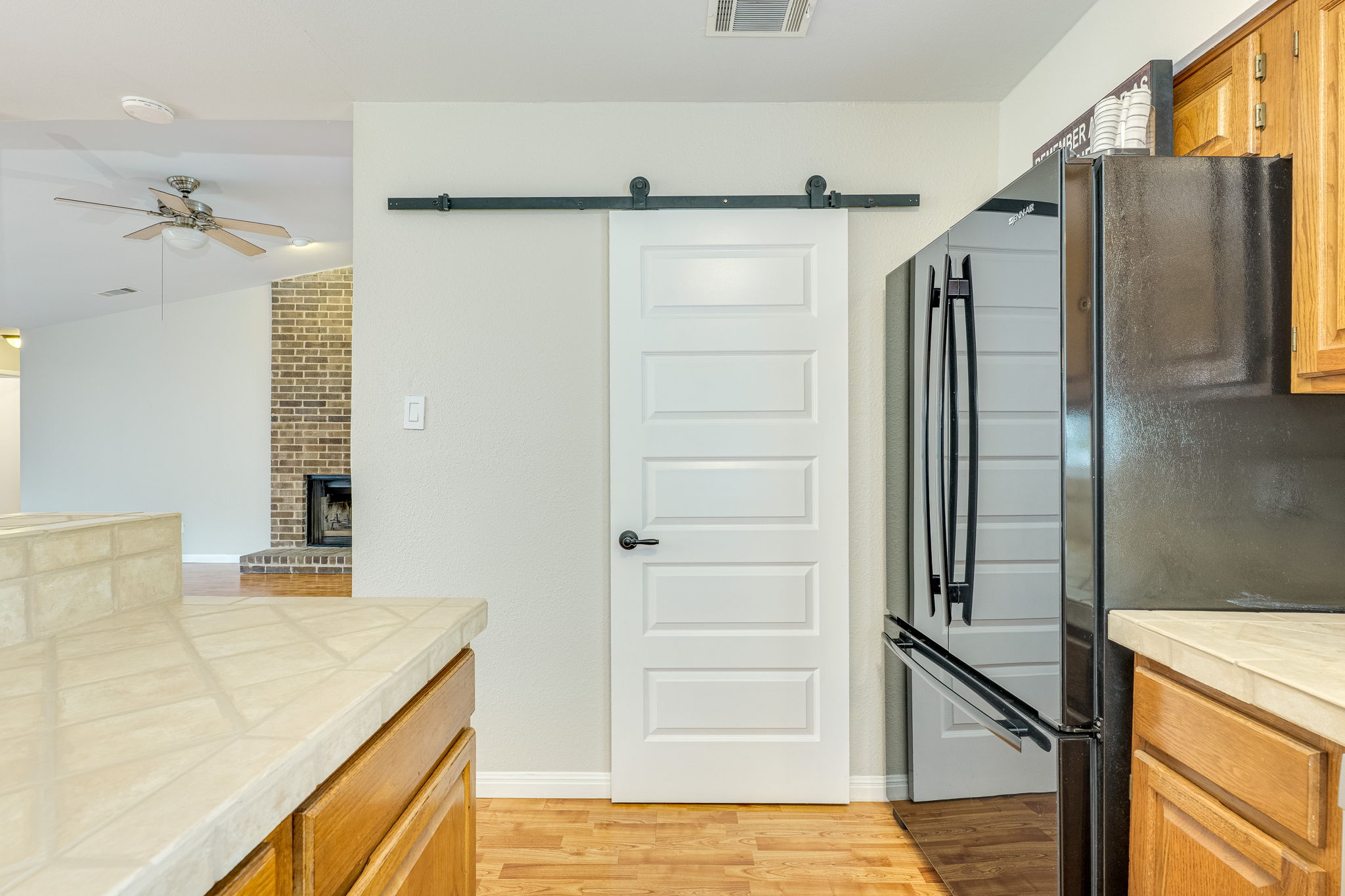 4815 Transit Circle Austin, TX 78727 - Photo 18 of 35 A contemporary barn door conceals the spacious pantry, adding both style and functionality to the space.