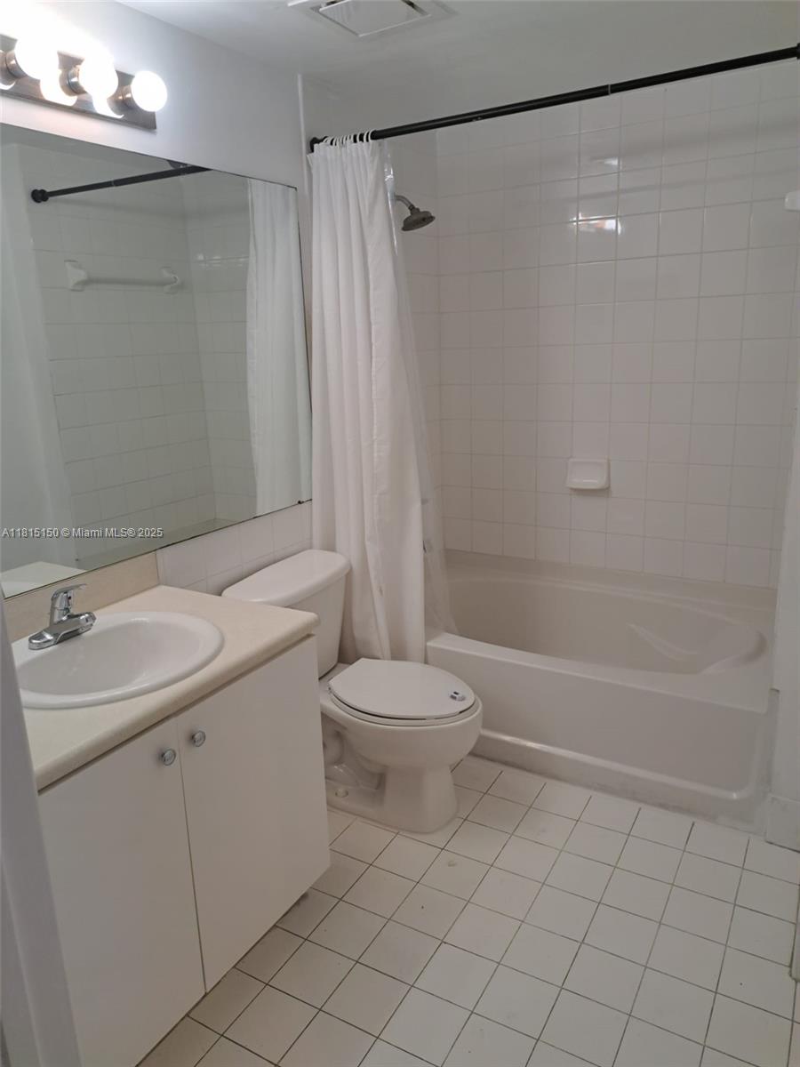 5077 Northwest 7th Street, Unit 1505 Miami, FL 33126 - Photo 11 of 30 a bathroom with a sink a toilet and shower