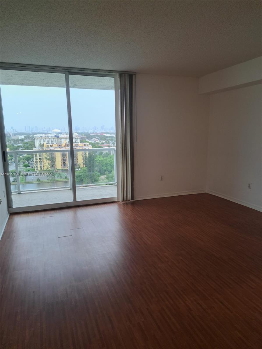 5077 Northwest 7th Street, Unit 1505 Miami, FL 33126 - Photo 2 of 30 a view of a room with wooden floor and walls
