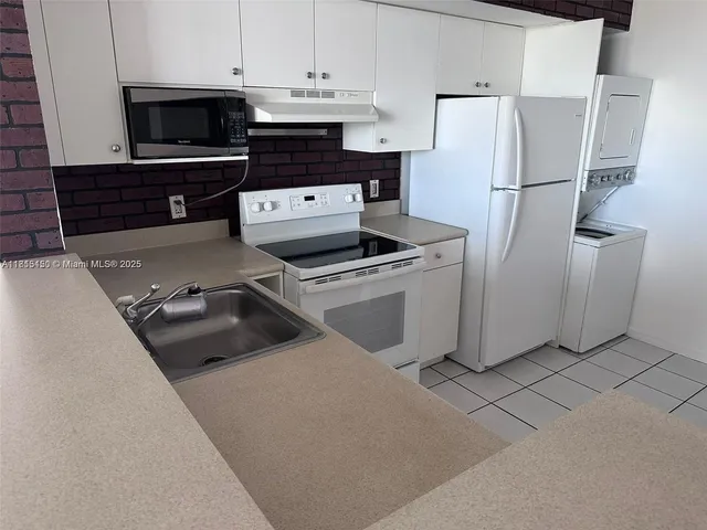 a kitchen with a refrigerator stove and cabinets