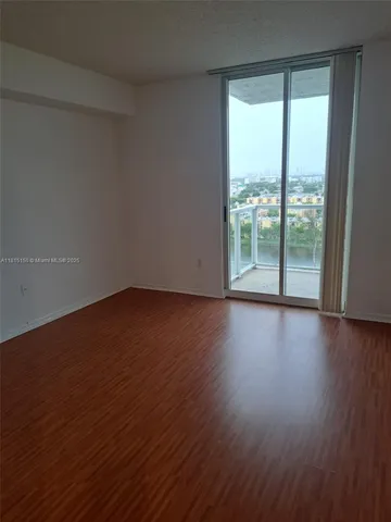 a view of wooden floor and brick walls
