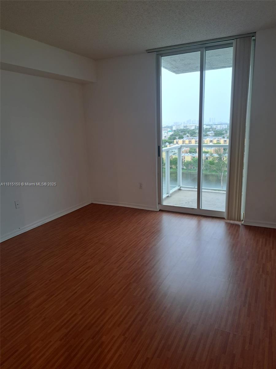 5077 Northwest 7th Street, Unit 1505 Miami, FL 33126 - Photo 9 of 30 a view of wooden floor and brick walls