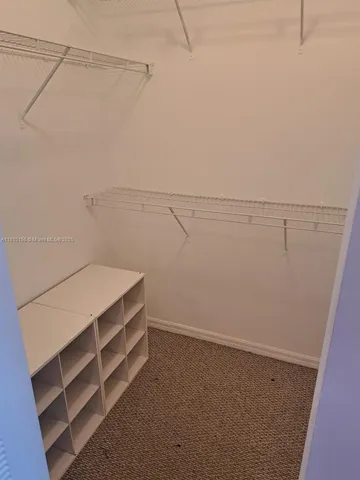 a view of storage and utility room with racks on the wall