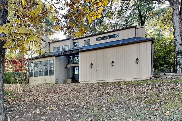a view of a house with a bunch of trees