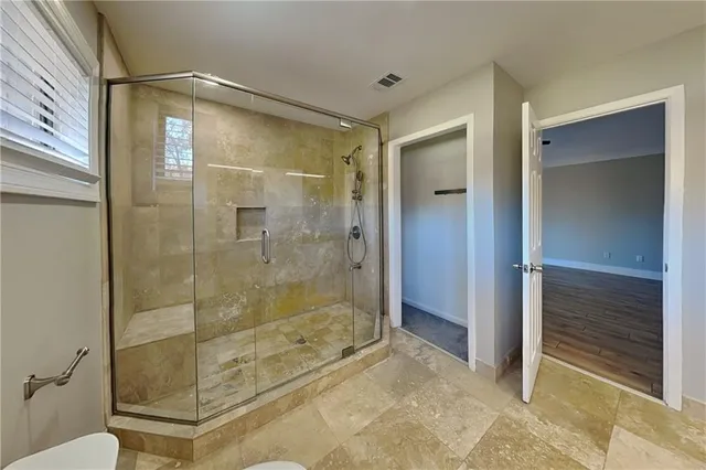 a bathroom with a shower and a sink
