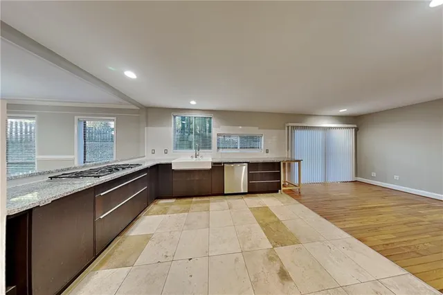 a large kitchen with stainless steel appliances granite countertop a large counter top and a stove