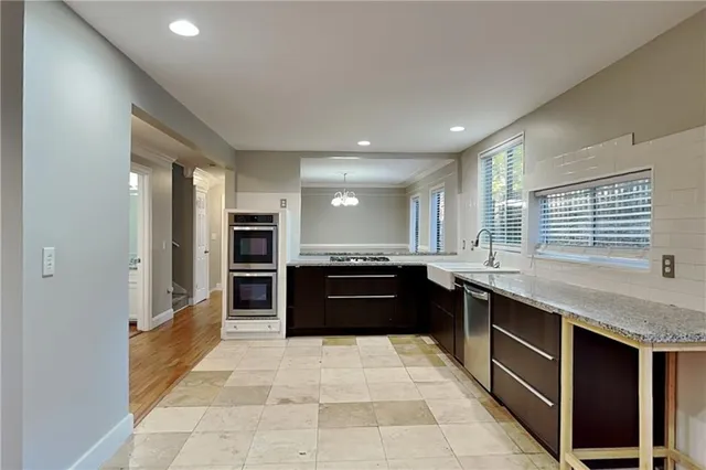 a large kitchen with a large counter top and stove