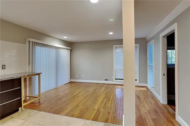 wooden floor in an empty room with a fireplace