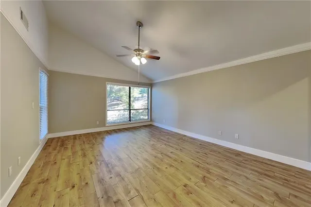 wooden floor in an empty room with a window