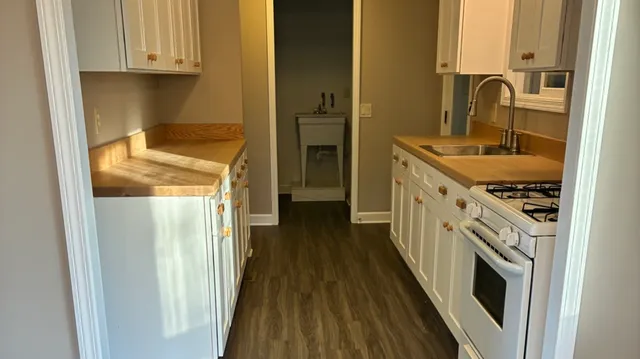 a kitchen with a sink cabinets and appliances