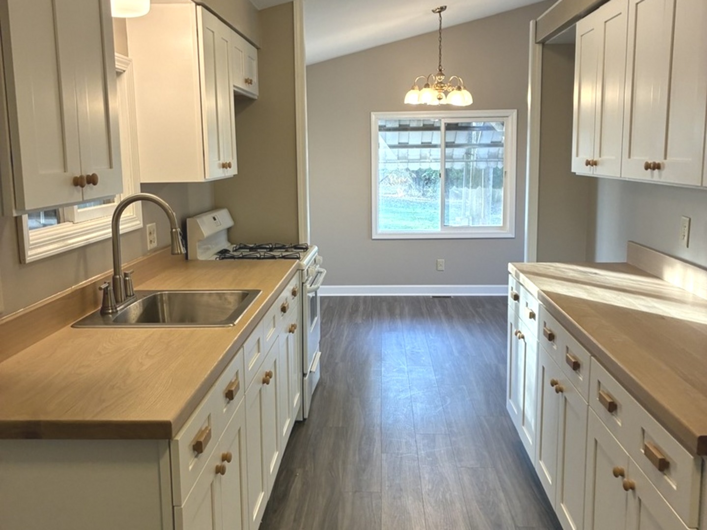 315 East Corning Road Beecher, IL 60401 - Photo 5 of 16 a kitchen with a sink a window and wooden floor
