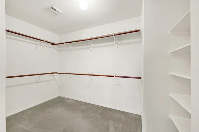 a spacious bathroom with a tub sink and a mirror