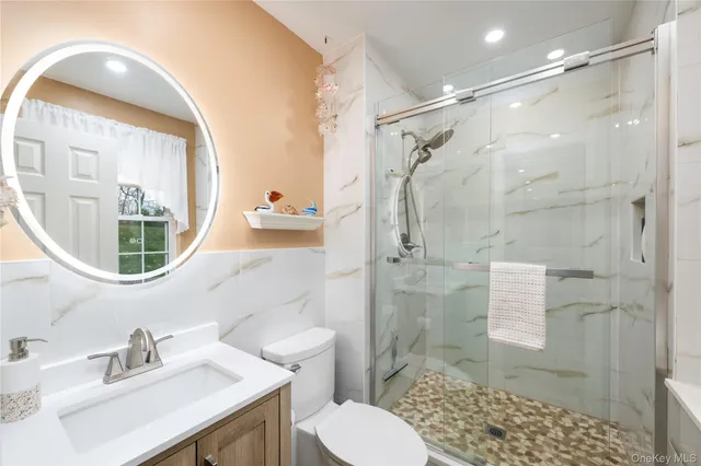 a bathroom with a sink toilet and shower