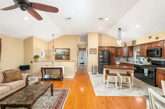 a living room with furniture a fireplace and kitchen view