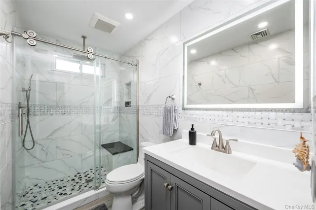 a bathroom with a sink toilet and shower