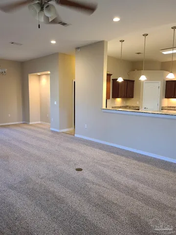 a view of a kitchen with a sink and chandelier
