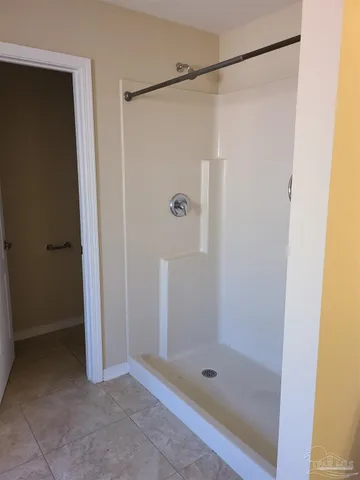 a bathroom with a glass shower door