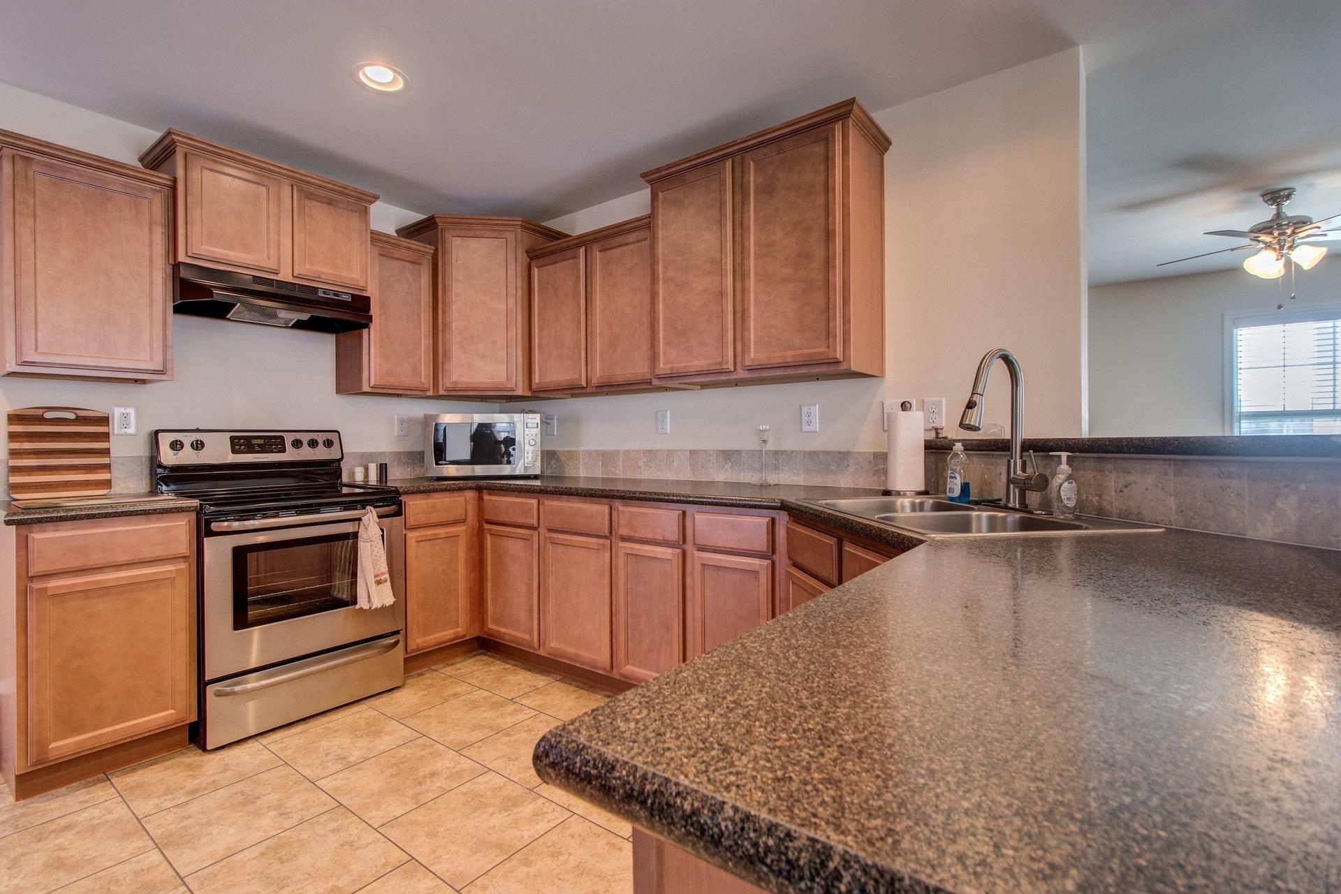 1381 Nemmo Road Vinton, VA 24179 - Photo 11 of 39 a kitchen with stainless steel appliances granite countertop a sink stove and cabinets