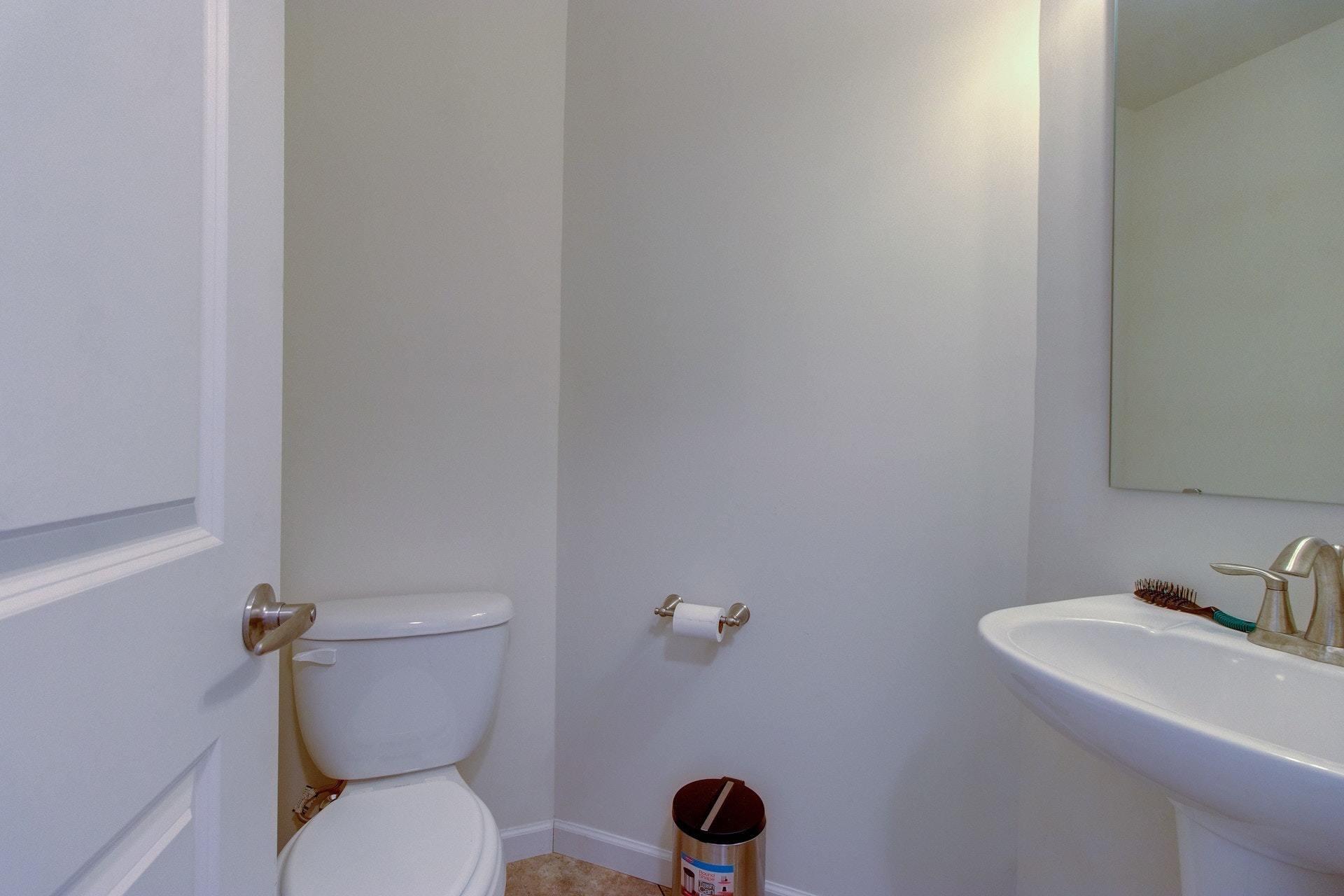 1381 Nemmo Road Vinton, VA 24179 - Photo 14 of 39 a white toilet sitting next to a bathroom sink