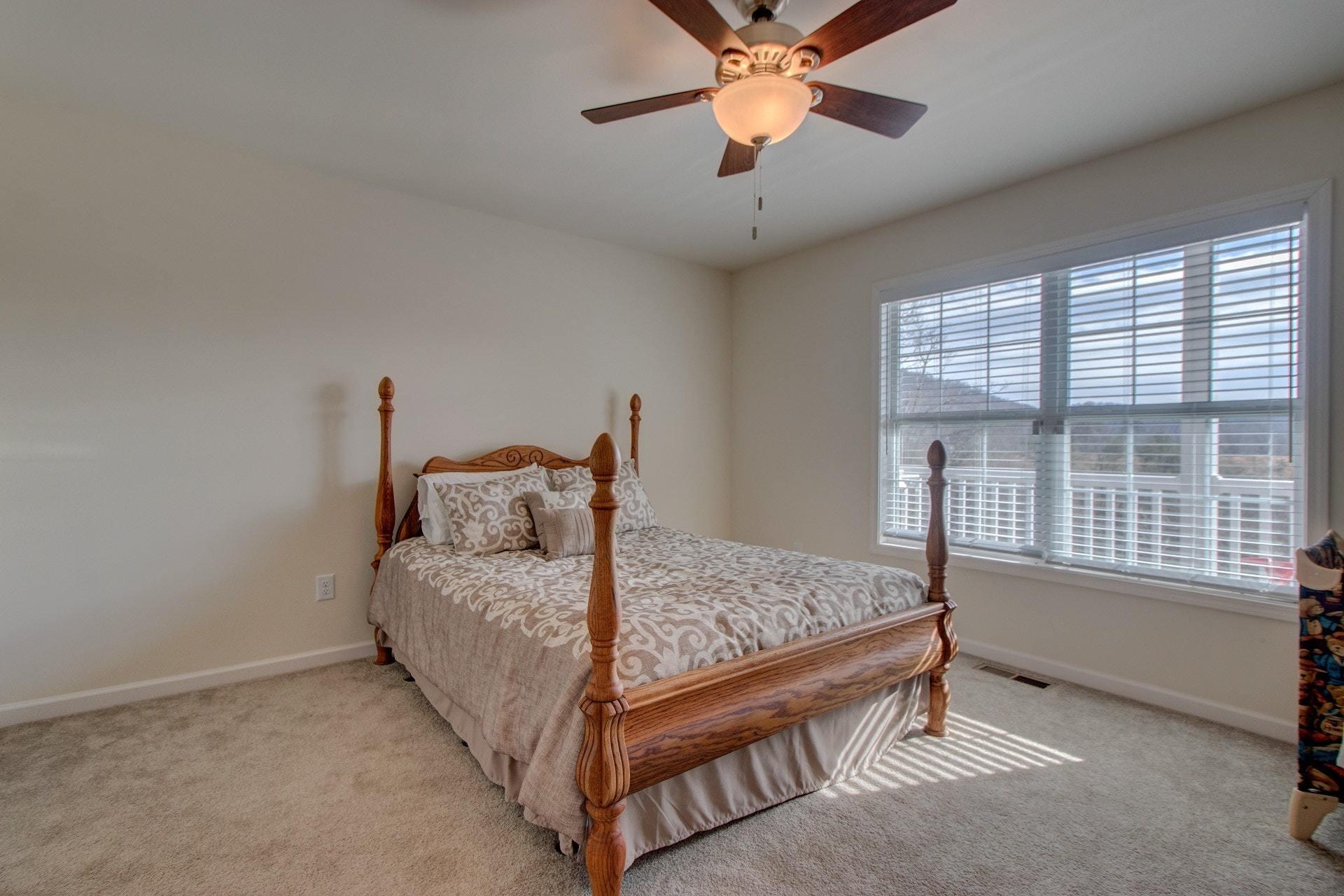 1381 Nemmo Road Vinton, VA 24179 - Photo 15 of 39 a bedroom with a bed and a chandelier
