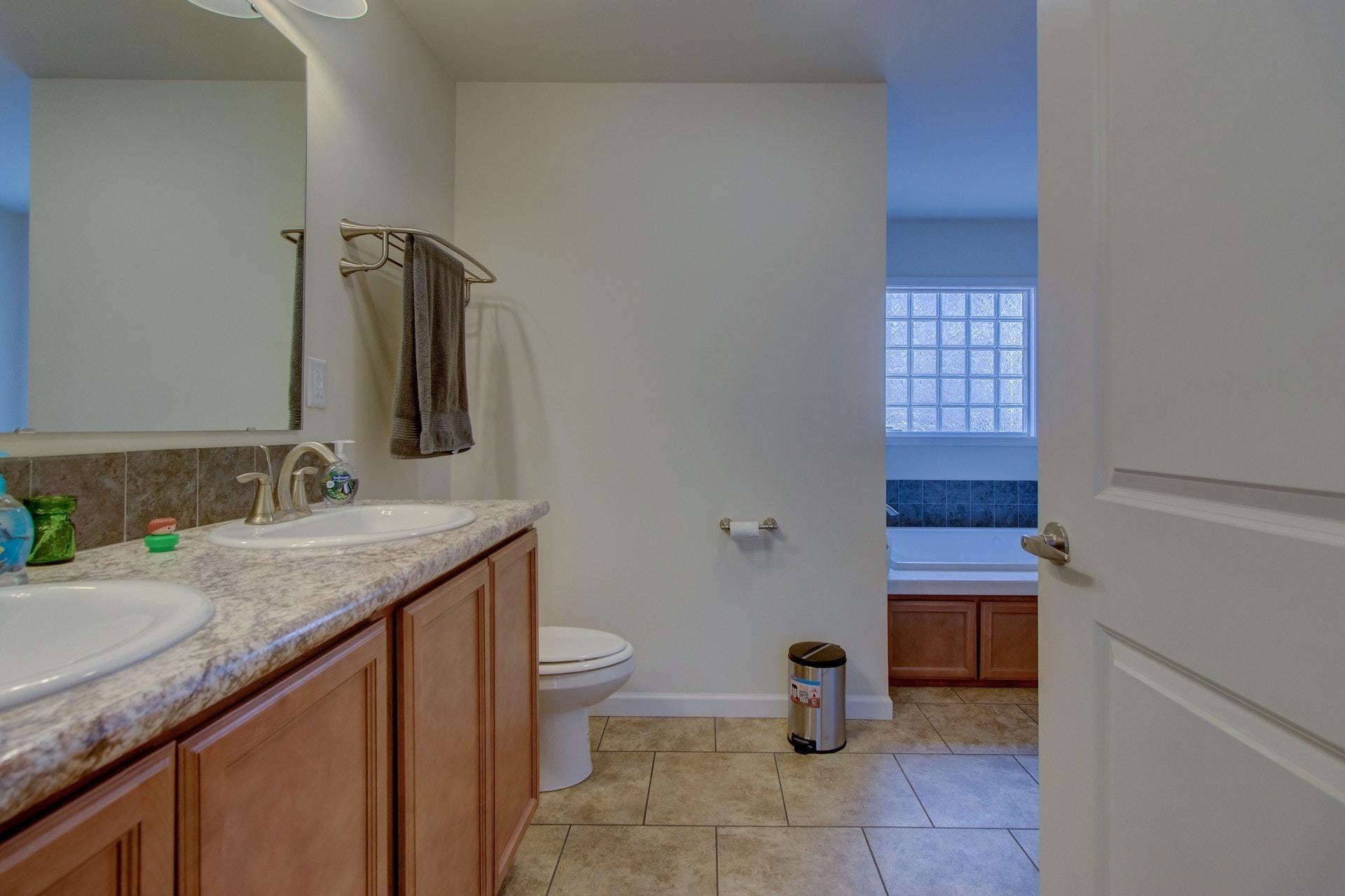 1381 Nemmo Road Vinton, VA 24179 - Photo 17 of 39 a bathroom with a granite countertop sink a toilet and a mirror