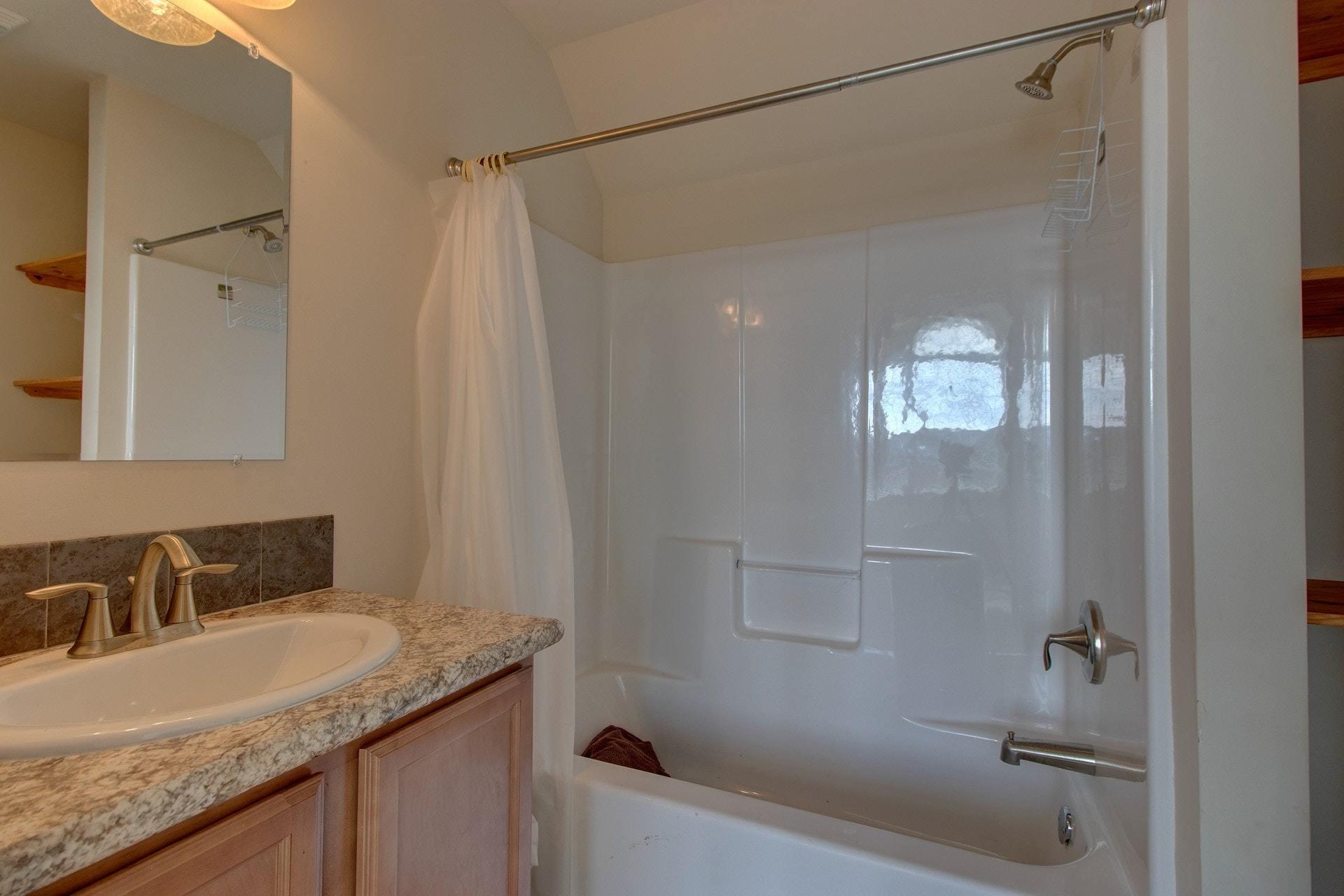 1381 Nemmo Road Vinton, VA 24179 - Photo 23 of 39 a bathroom with a granite countertop sink a toilet and shower